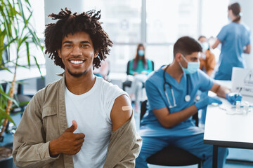 Successful flu Vaccination Concept. Vaccinated African American Man Gesturing Thumb Up And Showing...