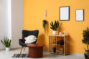 Armchair with cushions, shelving unit and coffee table in interior of living room