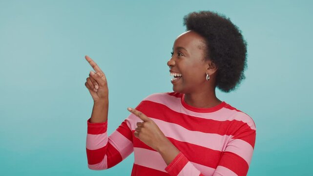 Choice, pointing and face of black woman in studio for retail option, shopping budget plan and decision. Smile, mockup space and customer with person on blue background for discount code solution