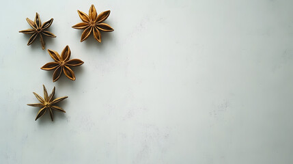 A minimalist arrangement of star anise on a white surface, focusing on the elegance of its symmetrical star shape and intricate texture.
