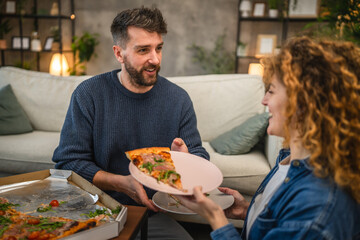 husband and wife eat pizza at home having time together with food