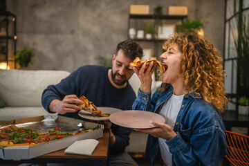 husband and wife eat pizza at home having time together with food