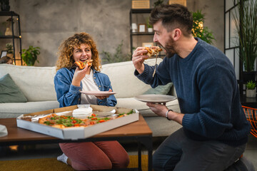 husband and wife eat pizza at home having time together with food