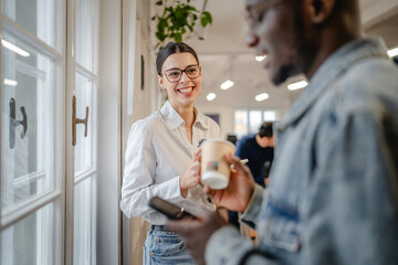 female and male colleague enjoy on the coffee break at office