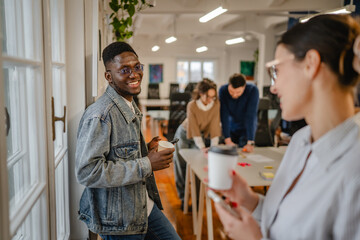 female and male colleague enjoy on the coffee break at office