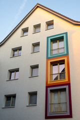 Facade of apartment buildings in Hannover, Germany. Exterior of residential building with colored window frames. Vertical orientation