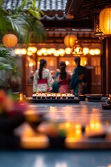 Three women in kimonos, enjoying a sushi platter at a beautifully lit restaurant.