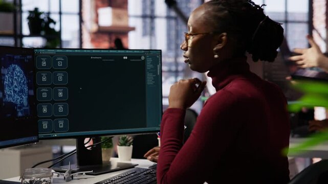 IT technician in startup office using large language model to get help with coding project. IT specialist interacting with AI LLM chatbot on PC in software development business company, camera B