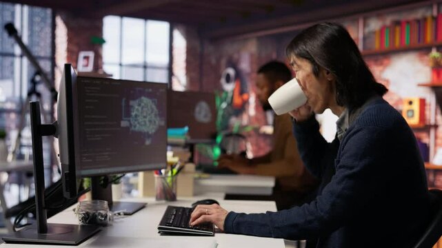 Software engineer in small business workspace using computer to oversee artificial intelligence neural networks. Person in tech startup office using AI machine learning systems on PC, camera B