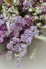 Colorful bouquet of lilac and white flowers arranged with delicate detail in a natural setting