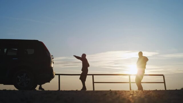 A silhouetted dancing friends adventure at sunset, filled with joy and memorable bonding moments