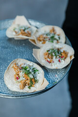 Delicious chicken tacos served on a tray at a lively social gathering