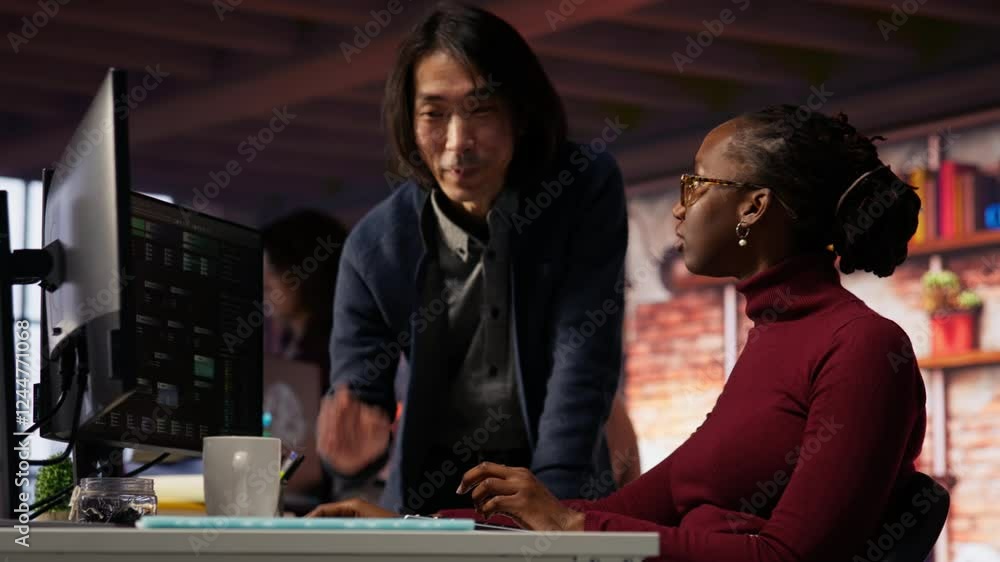 Poster cheerful supervisor in artificial intelligence startup enjoying laughter with worker coding applicat
