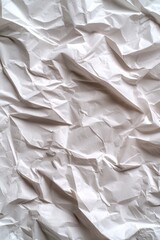 Obraz premium A close-up of crumpled white paper, showcasing texture and folds.