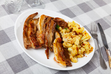 Delicious roasted lamb with cauliflower served on platter