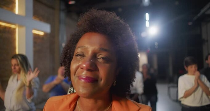 Tearful woman smiling during worship, deeply moved by faith and spirituality, illuminated cross in the background symbolizing hope and heartfelt devotion
