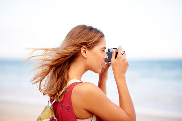 Woman, camera and beach photography on vacation, sightseeing location and tourist to capture view....