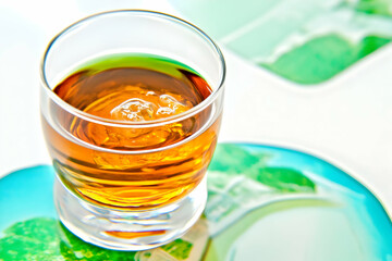 Golden Liquid Fills a Clear Glass on a Vibrant Saucer with a Soft Background.