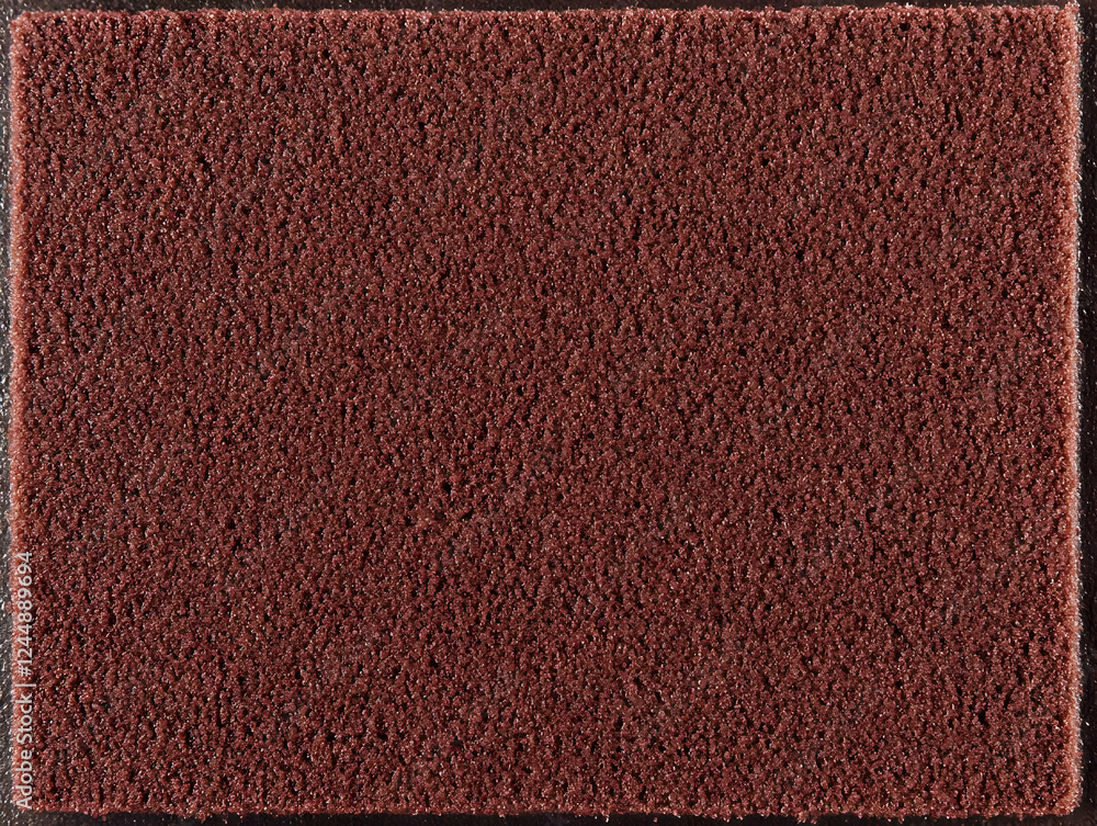Poster close-up view of a dark red textured surface displays a fine, granular pattern evenly distributed.