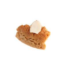 Piece of tasty cookie with almond flake isolated on white