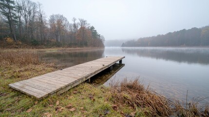 Misty lake dock, autumn woods, calm water, tranquil scene, nature photography