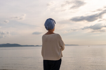 Woman wearing a headscarf, a common symbol of strength among cancer patients undergoing treatment...