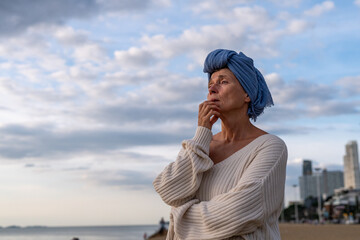 Woman wearing a headscarf, a common symbol of strength among cancer patients undergoing treatment...