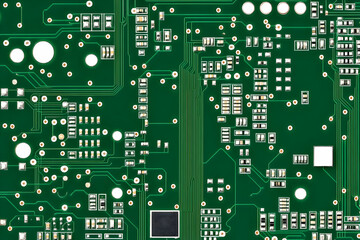 Close-up Photo of Green Circuit Board Shows Intricate Electronic Components and Pathways.