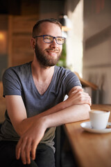 Thinking, man and smile with coffee at cafe for morning start, past reflection and nostalgia. Male person, contemplation and beverage drink with customer experience, memory and hospitality services
