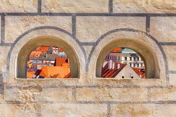 Summer cityscape - top view through the loopholes of the Cesky Krumlov Castle to the historical...