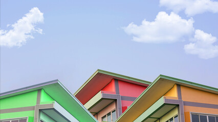 Simple colorful Concrete House with Roof in Village for Sale, Basic Home for Medium Small Family Residential, Blue Sky and Cloud in Background with Copy Space.