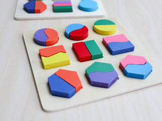 Colorful geometric wooden puzzle toy. Montessori system for early childhood development. Vivid elements that will help develop fine motor skills of hands and analytical thinking. selective focus.