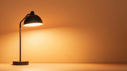lone desk lamp casting soft glow on simple workspace