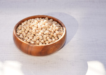 Dried chickpea in wooden bowl. Healthy food.