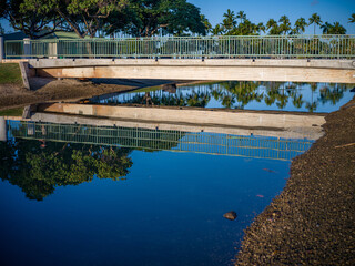 White and Teal Walking Bridge with Water Reflections.