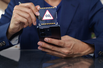 Caution Sign for Carbon Dioxide Displayed on Mobile Phone Screen