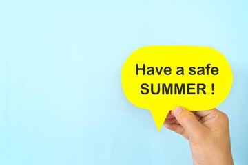 Summer essentials and safety tips reminder concept. Hand holding bright yellow speech bubble in blue background.