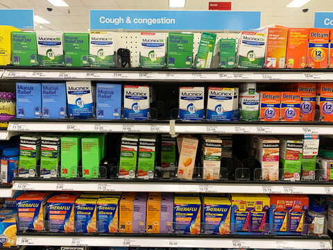 A retail store pharmacy shelf stocked with various cough and congestion medications Mucinex, Robitussin, Theraflu, and Delsym - California, USA - January 29, 2025