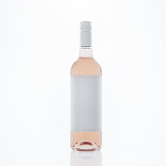 Frontal view of a clear glass bottle with rose wine with blanck white label for a mockup, on white background