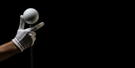 A person is holding a golf ball and pointing to it