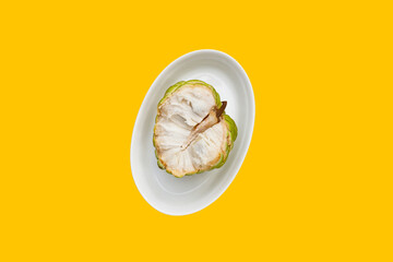 Custard apple fruit on yellow background.