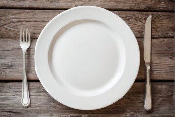White Plate and Silver Cutlery on Rustic Table