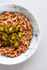 red pesto lentil quinoa topped with fresh jalapeno peppers