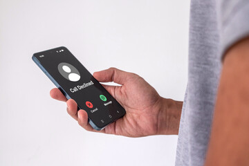 A man holding a mobile phone with Call Declined screen. Rejected phone call concept.