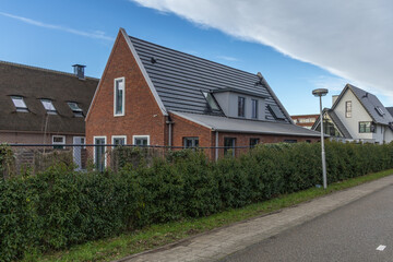Integrated solar panels on the roof of a Dutch House. Photovoltaic panels in the roof. Roof tile Of...