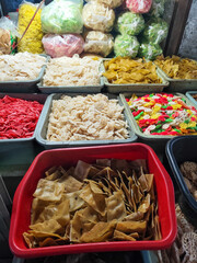 Raw cracker trader at a traditional market in Indonesia.