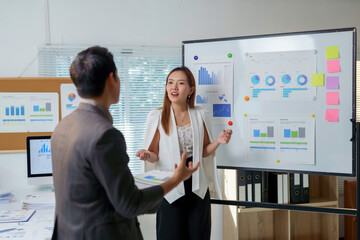 Asian businesspeople discussing and brainstorming about business performance in the office