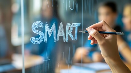 Hand writing smart on transparent board in education setting with blurred students background