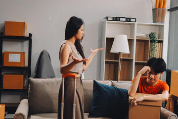Young Asian married couple after a fight, Angry couple ignoring each other, relationship troubles.