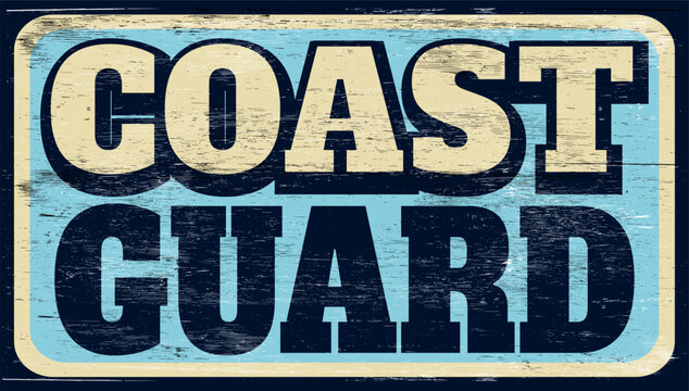 Aged and worn coast guard sign on wood